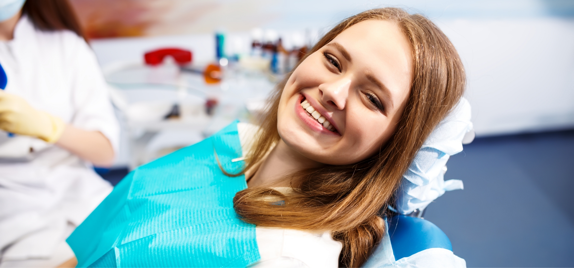 Happy dental patient sitting in a chair after successful cosmetic treatment at Murias Dental
