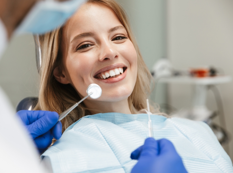 Smiling dental patient during check-up at Murias Dental clinic